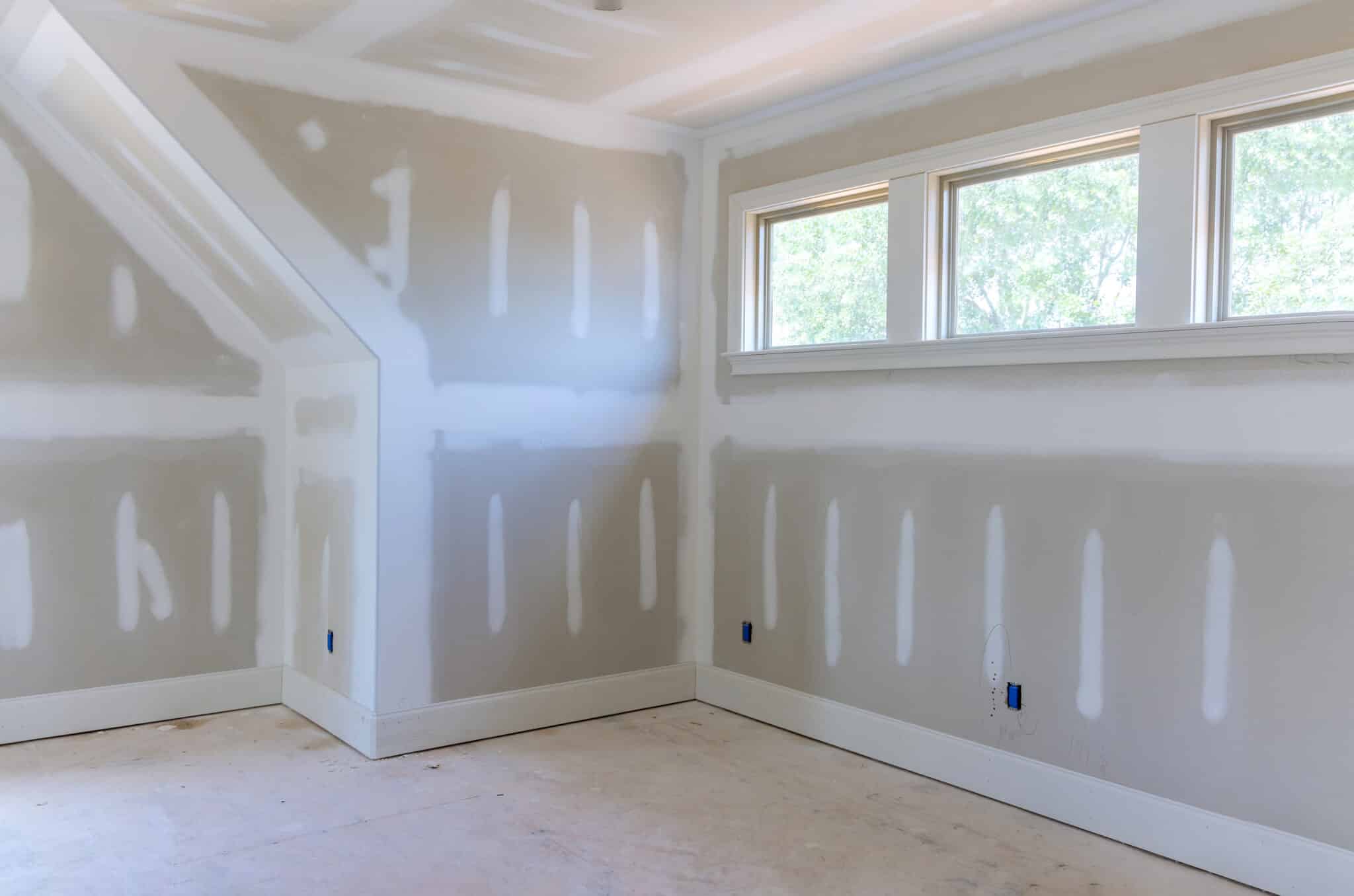 Finishing plastering drywall in ready for paint with new house